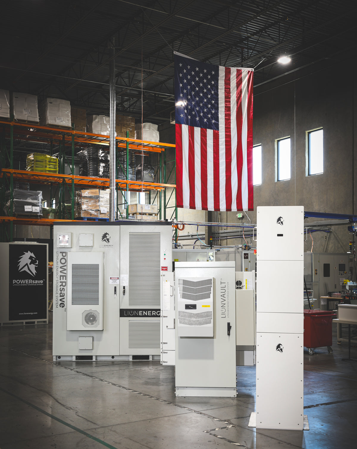 Lion Energy products lined up under an American flag in the Lion Energy warehouse